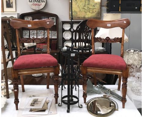 A cast iron umbrella/stick stand (missing tray) and a tall decorative candle holder