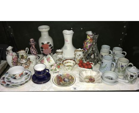 A shelf of mixed pottery and porcelain including cups, saucers, vases etc.