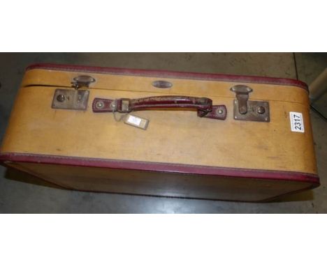 A vintage suitcase and contents including vintage wedding gown.