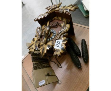 A cuckoo clock with 3 weights.