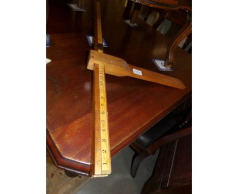 A vintage wooden folding height gauge.