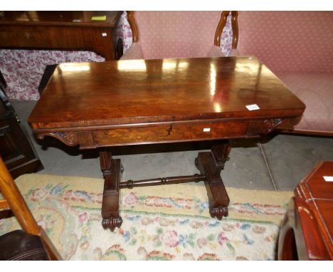 A Victorian rosewood fold over card table.