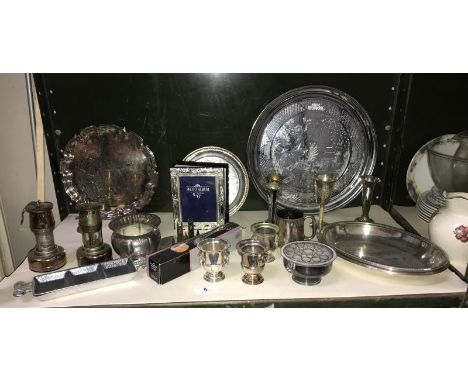 A shelf of plated ware including trays, miner's lamps etc.