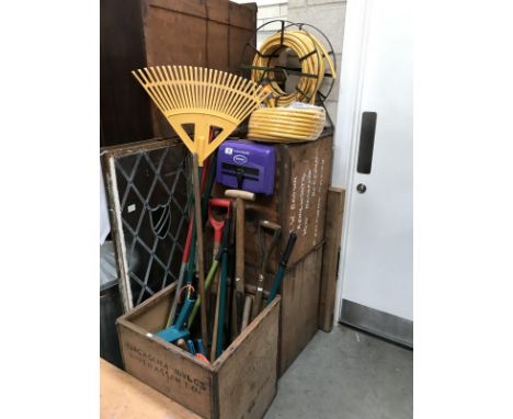 A mixed lot including garden tools, hose, tea chests etc.