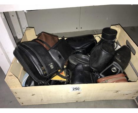 A box of camera lenses etc.