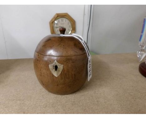A tea caddy in the shape of an apple.