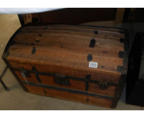 A wooden domed top trunk with inner tray.