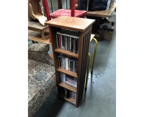 An oak CD rack with CD's