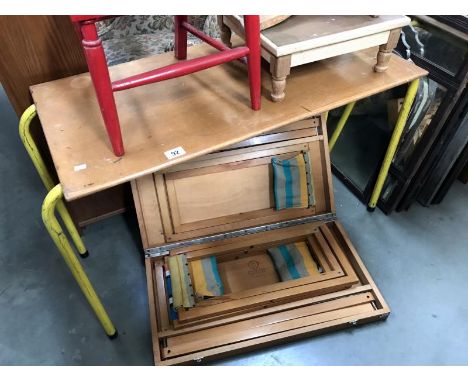 A picnic bench with stools and a vintage table