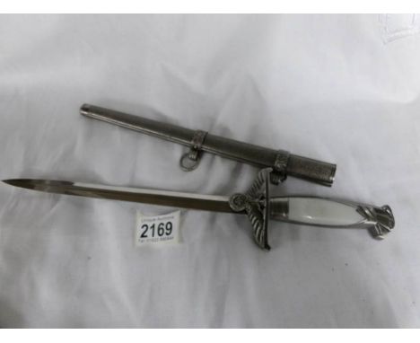 A small decorative replica Nazi Germany ceremonial dagger in scabbard.