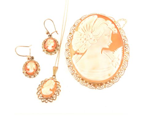 A modern carved shell cameo 47mm x 35mm, female profile facing right in a 9 carat yellow gold scroll and bead edge brooch mou