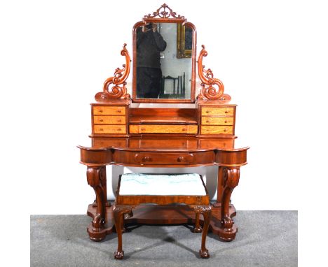 A Victorian mahogany dressing table, stepped arched plate below a carved and pierced shell surmount, with scrolled supports, 