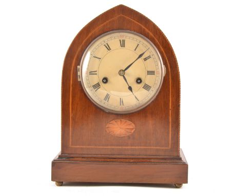 Edwardian inlaid mahogany lancet-shape mantel clock, cream coloured enamelled dial, movement striking on a gong, 31cm.