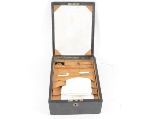 A lady's leather bound travelling stationery case, the fold down front having a blotter, the top having a kid leather folding
