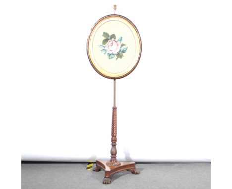 A pole-screen, replaced oval panel with gros point needlework, Regency tripod base, with a spiral twist, incurved platform, 1