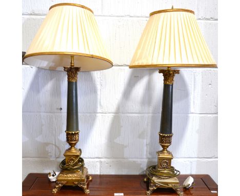 A pair of reproduction candlestick lamp bases, simulated stone columns, lion paw feet, 63cm inc. fittings.