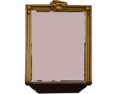 A composite gilt frame wall mirror, the rectangular frame mounted with shells, bevelled plate, above a shelf, 85cm x 61cm.