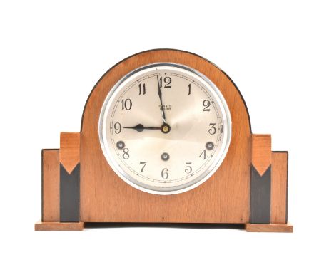 An Art Deco walnut and ebonised mantel clock, silvered dial, marked Flinn &amp; Co., Coventry, Garrard movement, striking on 