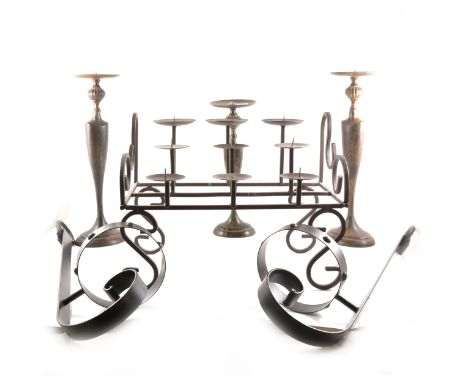 Wrought iron three-tier candle stand, width 40cm; a pair of wrought iron wall brackets; and three metal pricket candlestick.