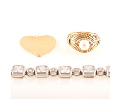 A yellow metal ring marked 14K set with a 6.5mm cultured pearl, gross weight approximately 7.3gms, ring size P, a 25mm heart 