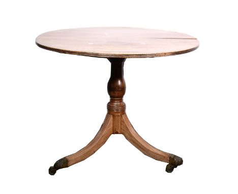 A Victorian mahogany tripod table, circular tilt top, with a reeded edge, turned and ringed column, tripod legs, paw feet, di