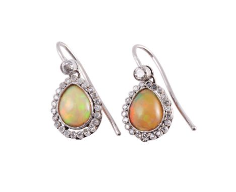 A pair of opal and diamond earrings, circa 1890-1900, the pear cut opal millegrain set within a surround of twenty three old 