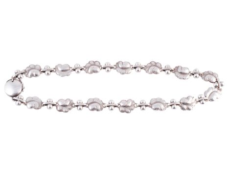 Georg Jensen. A silver necklace by Georg Jensen, formed of fourteen moulded leaf shaped mounts with hammered effect detailing