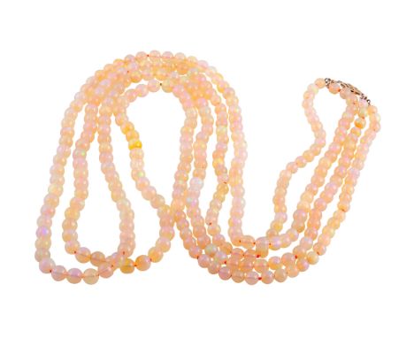 A double row necklace of opal beads, the two hundred and ninety two graduating opal beads strung simply into two rows on a pi