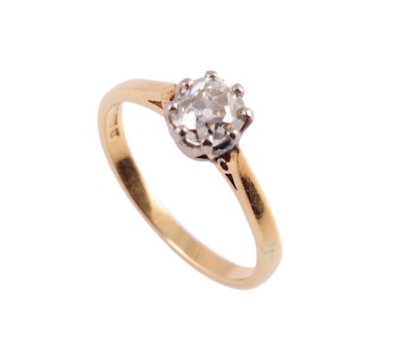 A diamond ring, the single cushion cut diamond eight claw set in a pierced detail mount between tapering open pierced detail 