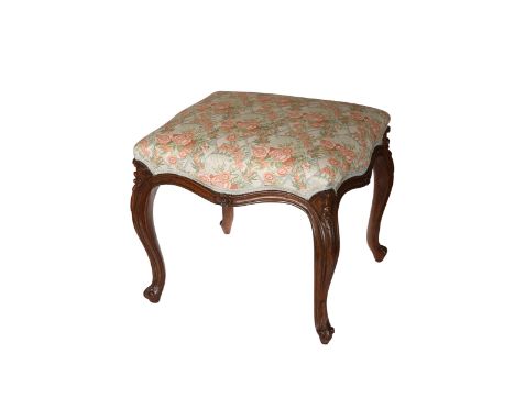 A rosewood salon stool, c. 1850, the rectangular stuffed over seat of serpentine outline, raised on cabriole legs, carved wit