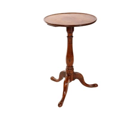 A George III red walnut tripod table, the circular dished top above a baluster stem continuing to downswept legs terminating 