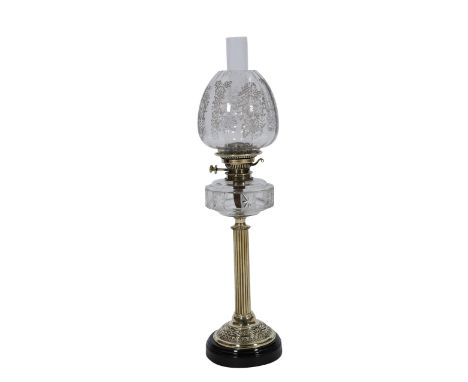 A Victorian brass and cut glass oil lamp, the columnar stem issuing from a domed base repousse with foliage, suspending a cir
