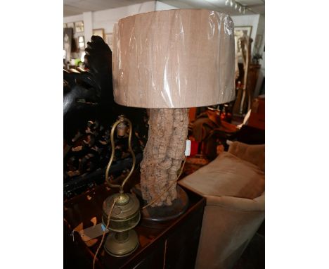 A French cork oak bark lamp, with stone linen shade, on circular base, H.77cm, together with a brass oil lamp converted to el