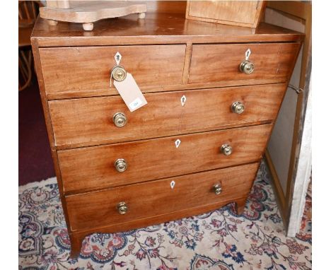 An early 19th century George III mahogany chest of two short over three long graduated drawers raised on splayed bracket supp