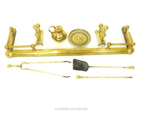 A collection of Victorian brass items, including an extendable fire curb, fireside tools, fire dogs, a Guernsey jug and a dis