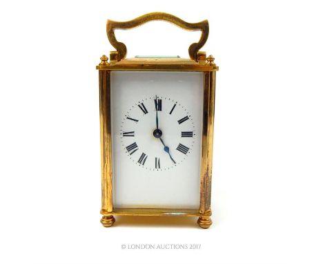 A 20th century gilt brass carriage clock of plain design with square glass aperture, 13.5 x 7 x 6cm.