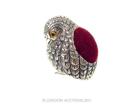 A sterling silver pin cushion in the form of a baby bird with intricate feather detailing and with a red, velvet pin section 