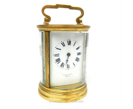 MALLET OF BATH A 20th CENTURY GILT BRASS CYLINDRICAL CARRIAGE CLOCK, having four bevelled glass panels and circular visual pl