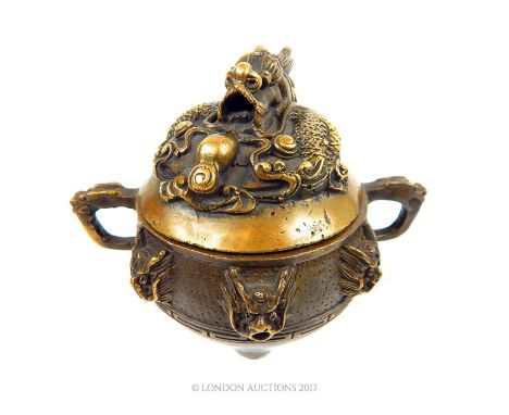 A fine, 20th century, Chinese, lidded, bronze censor with a writhing dragon on the lid, six dragon heads with open, pierced m