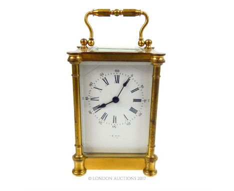 A 20th century gilt brass carriage clock, having classical style cylindrical columns, four bevelled glass panels and marked '