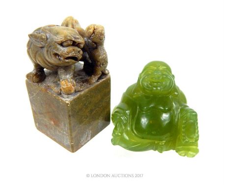 Two Chinese, carved items to include a carved green jade, smiling, seated, Buddha having two character marks to the base (8 x