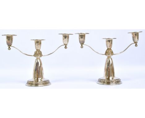 IRISH SILVER LTD; a pair of Irish hallmarked silver three branch candelabra with cast Celtic motifs to upper part and circula