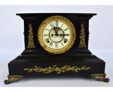 A late 19th century American Ansonia Clock Co black painted metal mantel clock, the circular two piece dial set with Roman nu