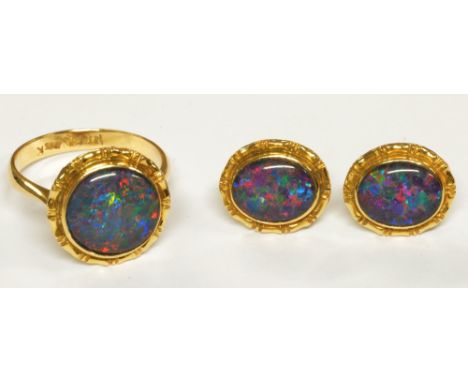 A 14ct yellow gold foil backed opal ring, size N and a matching pair of ear studs, combined approx 6.8g (3).