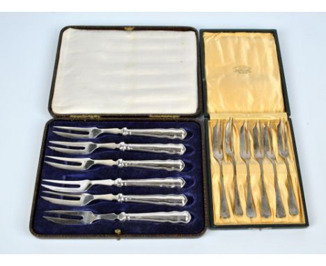 WILLIAM HAIR HASELER; a cased set of six George V hallmarked silver pastry forks, Birmingham 1922, and a further set of silve
