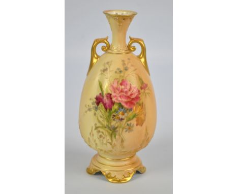 A Royal Worcester blush ivory gilt heightened floral decorated quadrilobed ovoid vase with waisted neck and scroll handles on