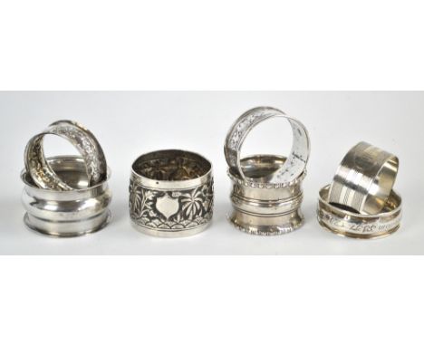 A group of six variously hallmarked silver napkin rings including an engine turned decorated example, initialled 'AJP', Rober