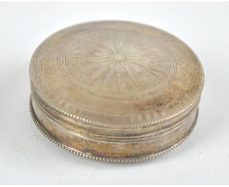 An early 19th century Dutch silver circular pill box with engine turned decoration and star burst motif to the hinged lid, da