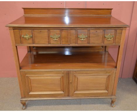 A large late 19th/early 20th century walnut buffet with pair of drawers above shelf and pair of cupboard doors, on cabriole l