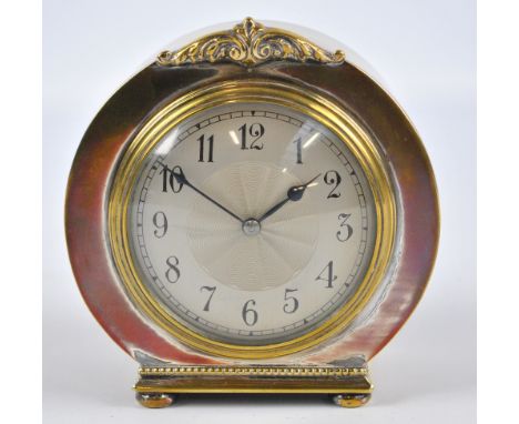 An early 20th century electroplated mantel clock, the circular silvered dial with Arabic numerals, with foliate scroll decora